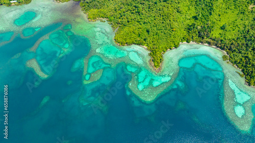 Aerial drone of tropical lagoon with turquoise water and coastline with tropical vegetation. Borneo, Sabah, Malaysia.