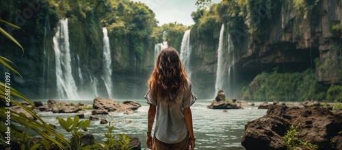 Millennial traveler captures stunning Southeast Asian nature on social media showcasing beautiful tropical waterfalls With copyspace for text