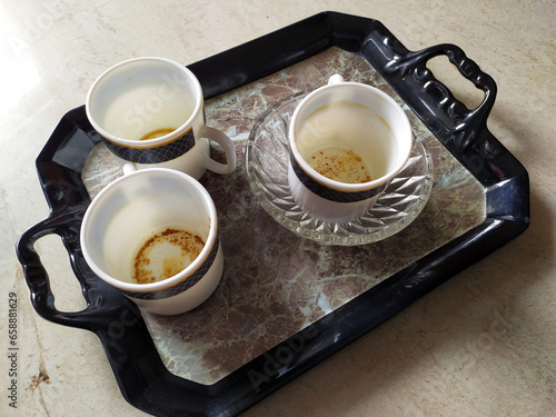 three white empty coffee mug put in a serving tray
