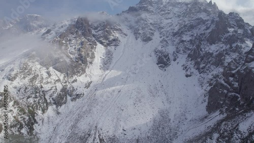 Wallpaper Mural Aerial shot of rising above the mountain peak in the clouds Torontodigital.ca