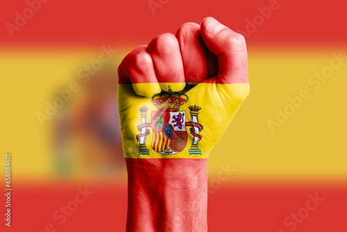 Man hand fist of SPAIN flag painted. Close-up. photo