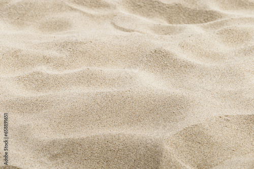 Beige Sand texture natural background. Close up sandy beach on shore sea, waves textured dunes, light color, minimal nature fon. Summer and travel, spa and rest concept. Selective focus.