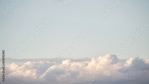 Beautiful blue sky and pearl fluffy cloud with sunrise in the morning. Natural background or atmosphere wallpaper