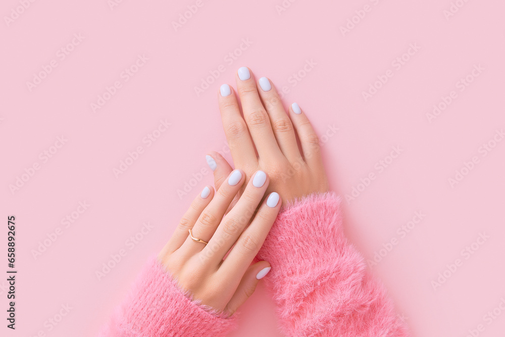 Womans hands with white manicure on pink background - obrazy, fototapety, plakaty 