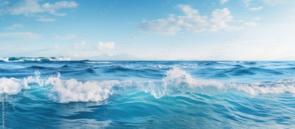 Tiny waves crashing on the horizon under a clear sky With copyspace for text Tiny waves crashing on the horizon under a clear sky With copyspace for text