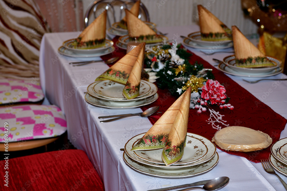 Close-up detail of a decorated Christmas table in a home during night