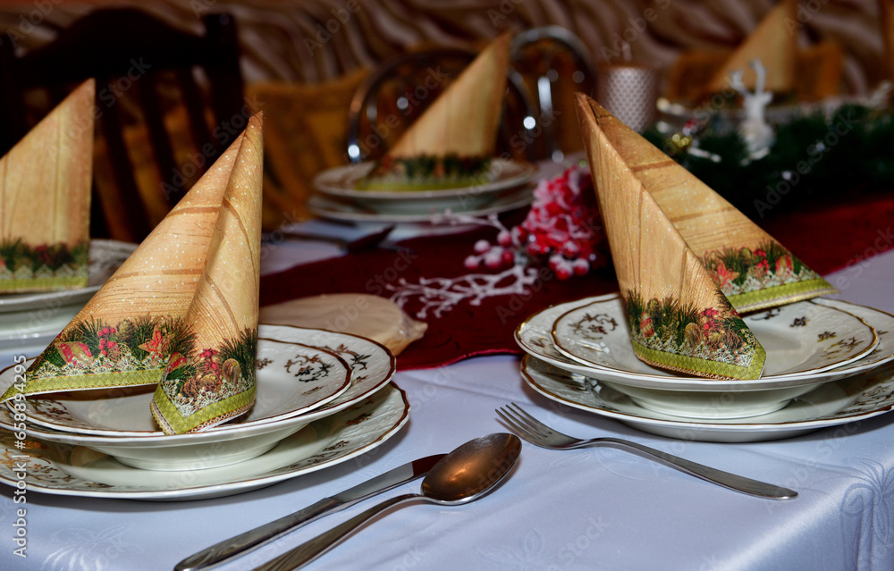 Close-up detail of a decorated Christmas table in a home during night