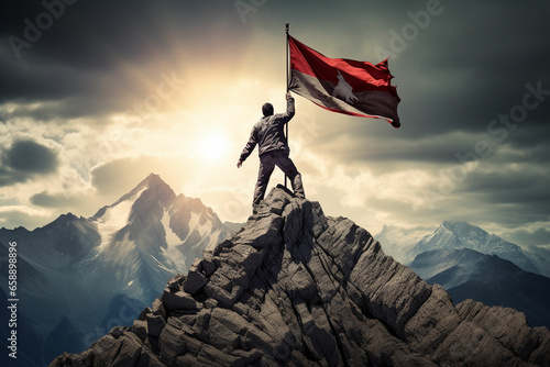 climber with flag conquering top of mountain © msroster