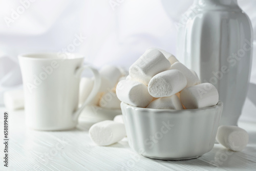 White marshmallows on a wooden table.