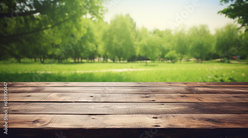 A wooden table overlooking a lush green meadow under a clear sky, nature-based theme, product display