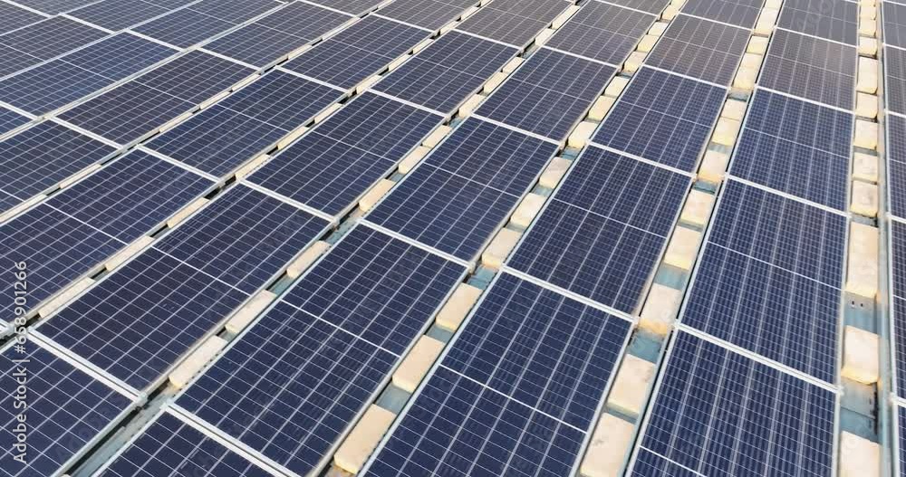 Aerial video of solar panels install on a flat commercial, industrial roof, with concrete blocks. Aerial video of solar panels install on a flat commercial, industrial roof, with concrete blocks.