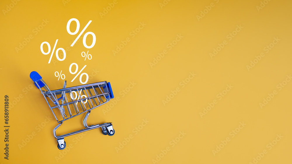 Sale percentage falling in shopping car on yellow background. Shopping online concept, Special price products, Specialand promotion. - obrazy, fototapety, plakaty 