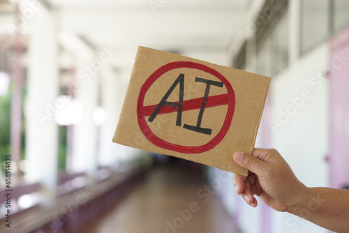 Close up hand holds paper card with No AI,  prohibition sign. Concept, disagree, anti or don't support  or not allow to use AI or Artificial Intelligence in daily life.    