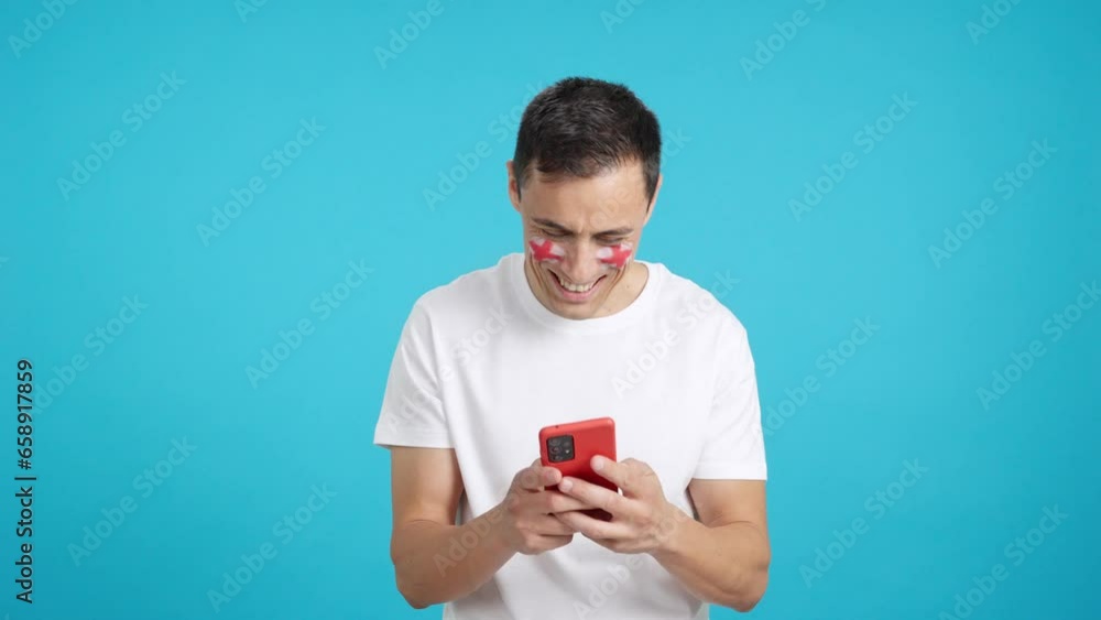 English man looking at his mobile smiling and showing it. English man looking at his mobile smiling and showing it.