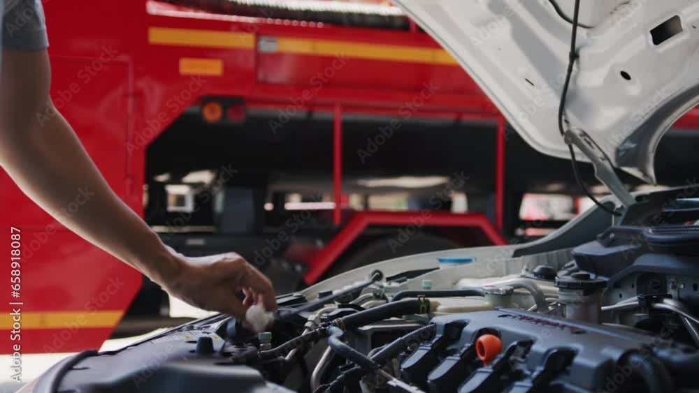 The mechanic is checking car engine in the garage, The mechanic is checking car engine in the garage,