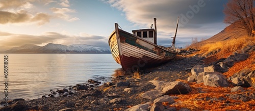 Abandoned fishing boat on the Barents Sea shore in Teriberka Russia With copyspace for text