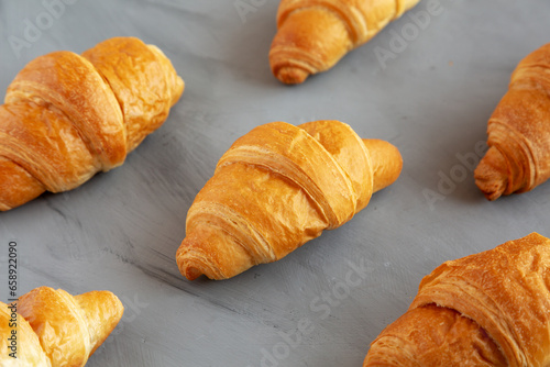 Cuadro en lienzo Homemade Croissants on a gray background, side view.
