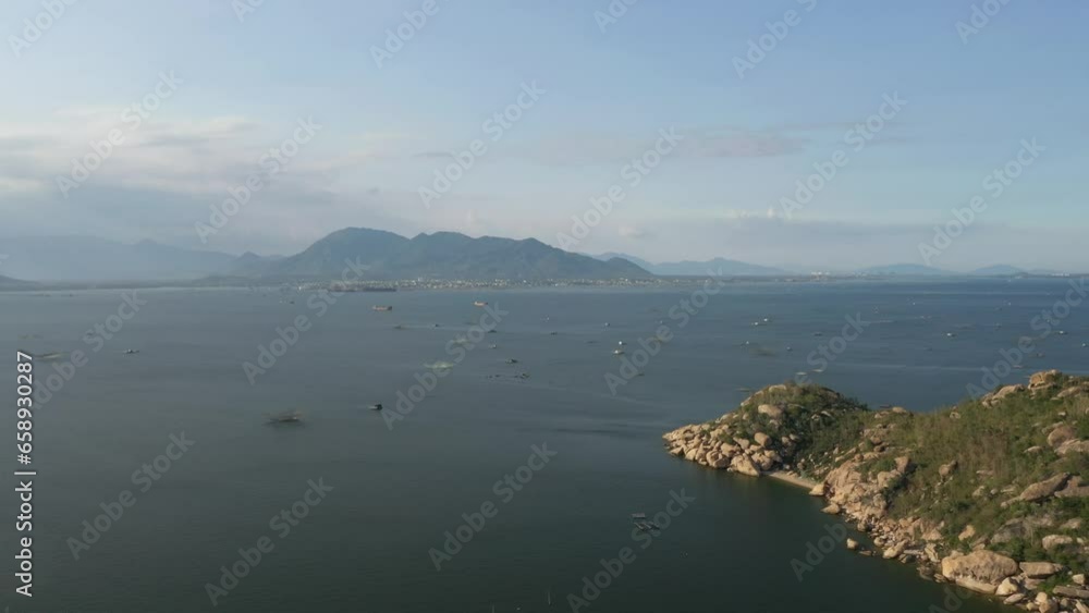 Cam Ranh bay aerial view with beautiful lagoon in turquoise colour and white boat, Lobster farm, flying over idyllic beach in Khanh Hoa, Vietnam Cam Ranh bay aerial view with beautiful lagoon in turquoise colour and white boat, Lobster farm, flying over idyllic beach in Khanh Hoa, Vietnam