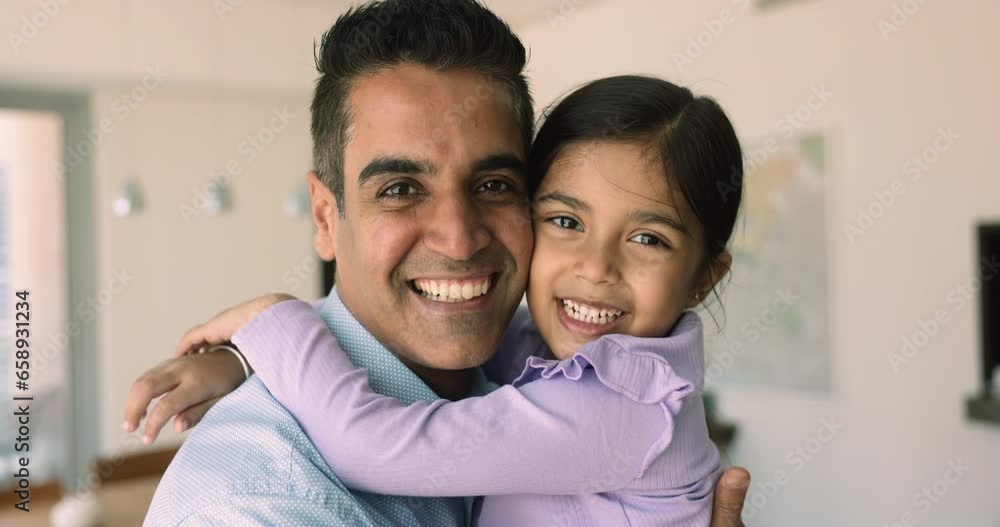 Close up faces of middle-aged Indian daddy play with little 5s beautiful daughter, laugh, enjoy priceless time together at home. Family ties, happy fatherhood, unconditional love between kid and dad Close up faces of middle-aged Indian daddy play with little 5s beautiful daughter, laugh, enjoy priceless time together at home. Family ties, happy fatherhood, unconditional love between kid and dad