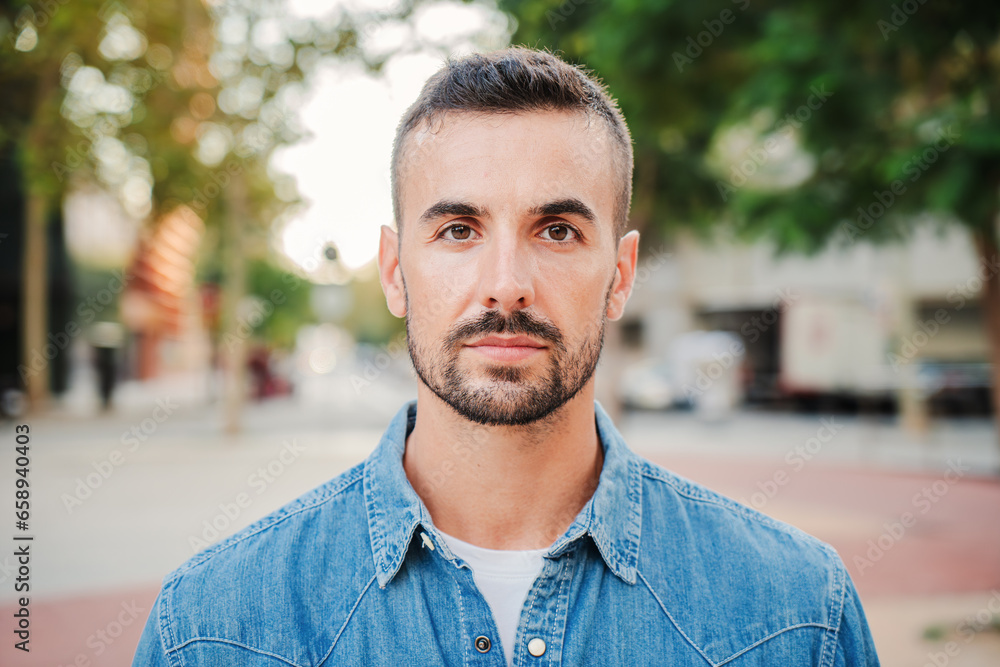 Close up individual portrait of handsome serious guy looking at camera standing outdoors. Front view of young real man with pensive expression. Head shot of one formal adult male staring thoughtful Close up individual portrait of handsome serious guy looking at camera standing outdoors. Front view of young real man with pensive expression. Head shot of one formal adult male staring thoughtful