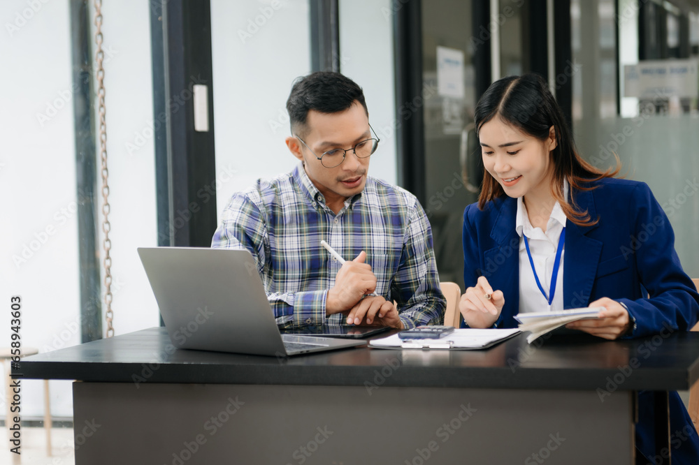 Female discussing new project with male colleague. Young woman talking with young man in office.. Female discussing new project with male colleague. Young woman talking with young man in office..
