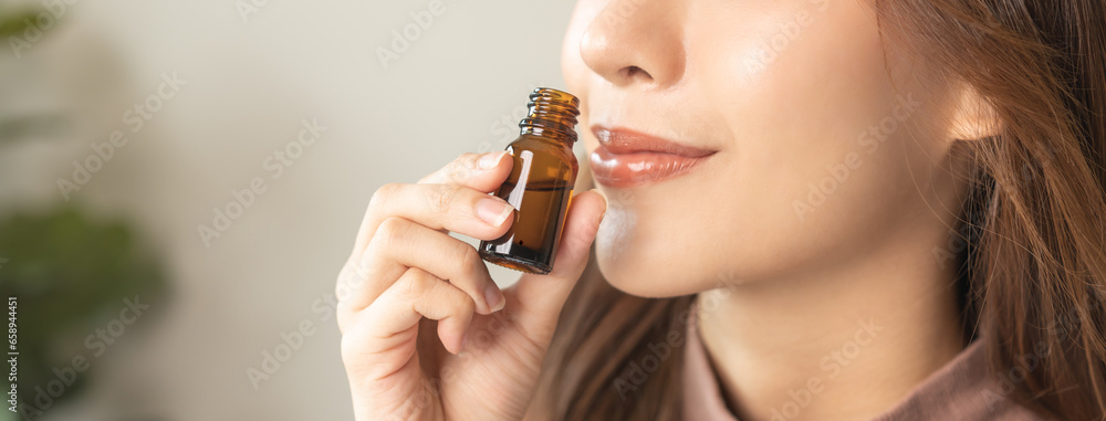 Aromatherapy, attractive asian young woman, girl face expression enjoying smell fragrance of herbal from medicine natural organic essential perfume oil at home. Therapy treatment, beauty skin care. - obrazy, fototapety, plakaty 