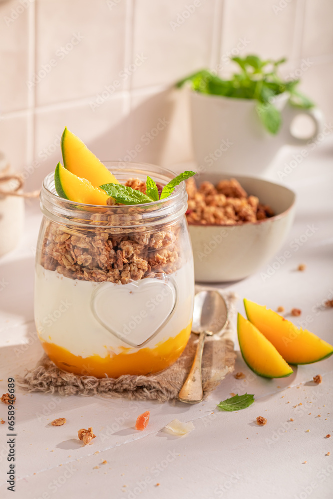 Healthy and fresh mango granola in spring kitchen for lunch. Healthy and fresh mango granola in spring kitchen for lunch.