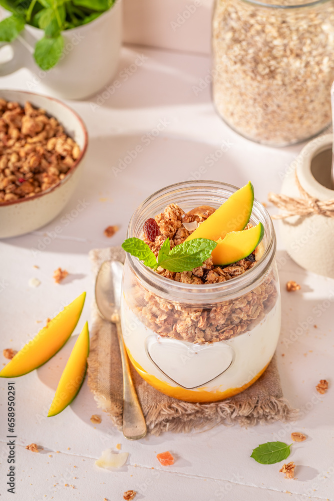 Tasty and sweet mango granola in spring kitchen for lunch. Tasty and sweet mango granola in spring kitchen for lunch.