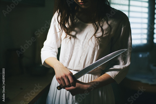 A girl holds a knife in her hand and wants to hurt herself  suicidal or self-harm tendencies in depressive disorder  depression  bipolar disorder  mania  mental illness  suicidal tendencies  despair