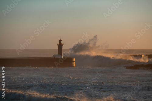 Porto lighthouse in Portugal with big waves.