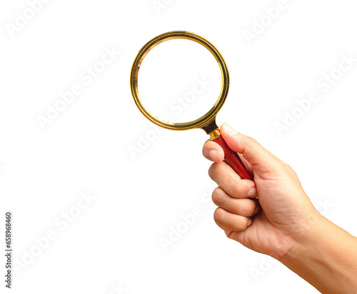 Close-up of hand holding a magnifying glass against a transparent background.