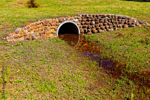 Description
Concrete culvert forming a grassy bridge over a drainage ditch with rock cladding near Riversdale in the Western Cape, South Africa photo