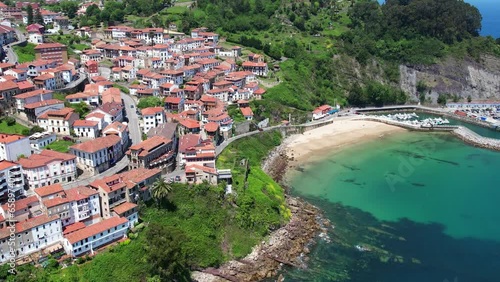 Aerial flyover above the beautiful seaside village of Llastres in the costa Verde of northern Spain photo