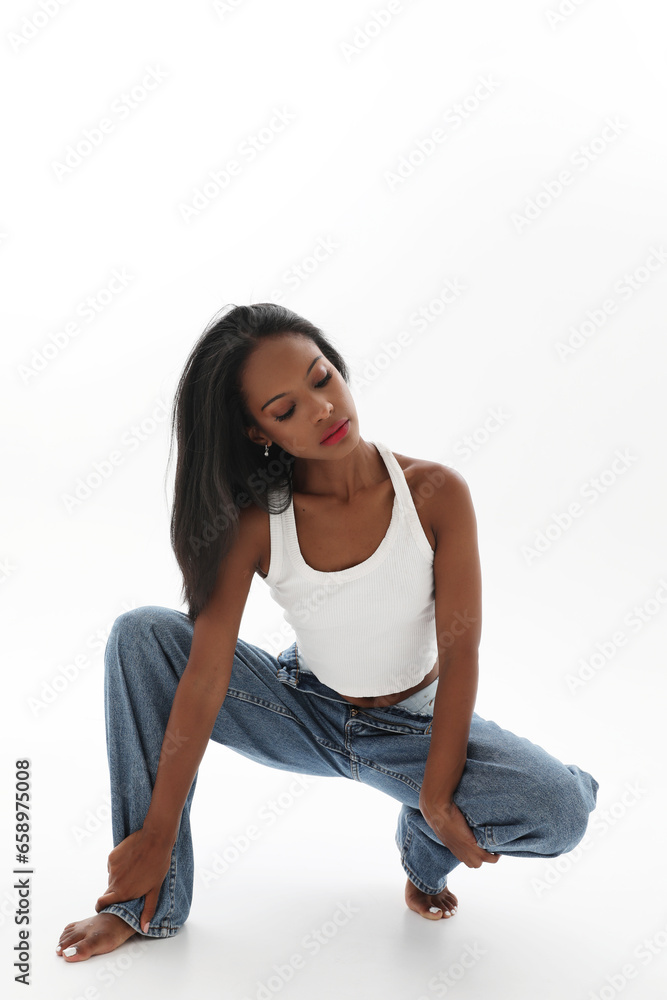 Studio portrait of young lovely woman with dark skin isolated over white wall.