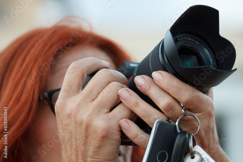 Primer plano de mujer fotografíando gaviotas en los Arenales del Sol, España photo