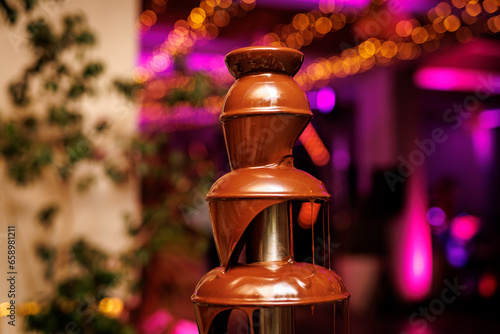 Liquid chocolate fountain at an event or celebration.