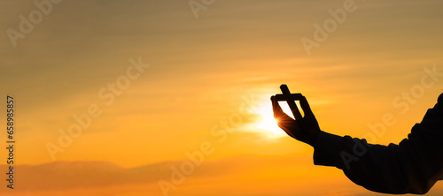 Silhouette of prayer woman worship God in the morning with sunrise sky background. Person hands open palm up worship. God helping repent catholic easter lent mind pray. Christian religion concept.