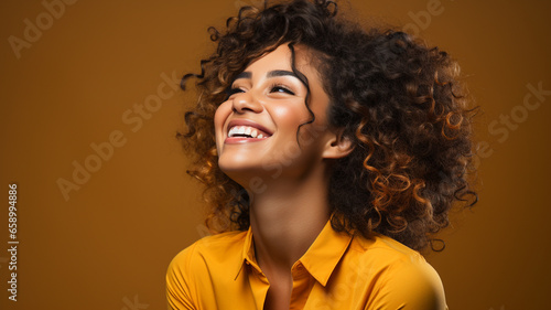 happy woman in casual clothes smiling and looking at camera on dark background.