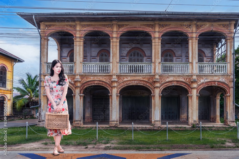 Φωτογραφία Thai female tourists visit at ancient architecture French style village in Tharae, Sakon Nakhon