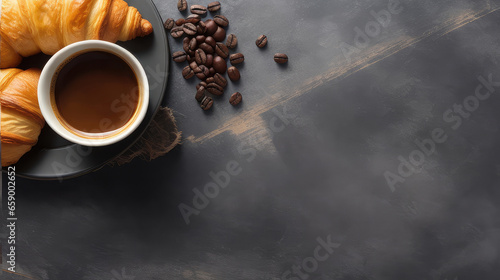 Croissant, mug of coffee and and coffee beans on a black stone table, top view, copy space on the right