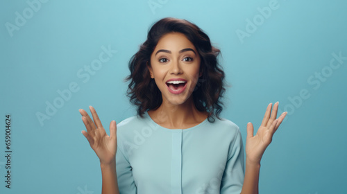 Energetic Promotion  A Vibrant Young Hispanic Woman Enthusiastically Advertising with Open Palms Against a Calming Pastel Blue Background..