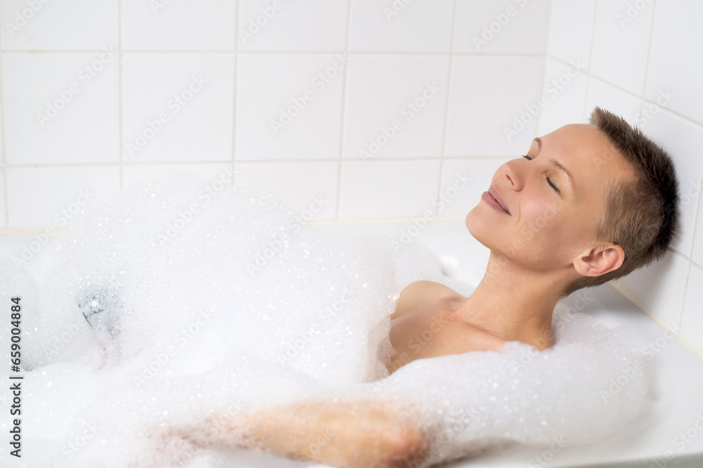 Middle-aged lady indulging in a luxurious bubble bath Middle-aged lady indulging in a luxurious bubble bath