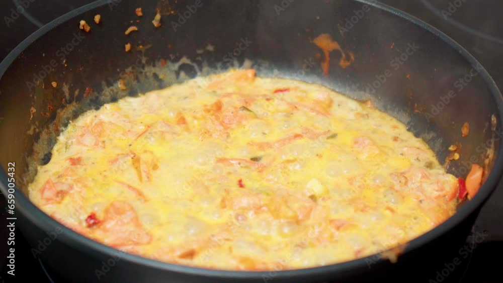 Cooking sauce with tomatoes and cream in a frying pan close-up. Selective focus Cooking sauce with tomatoes and cream in a frying pan close-up. Selective focus