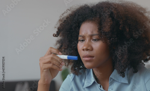 Worried African Woman Reacting to Pregnancy Test Results