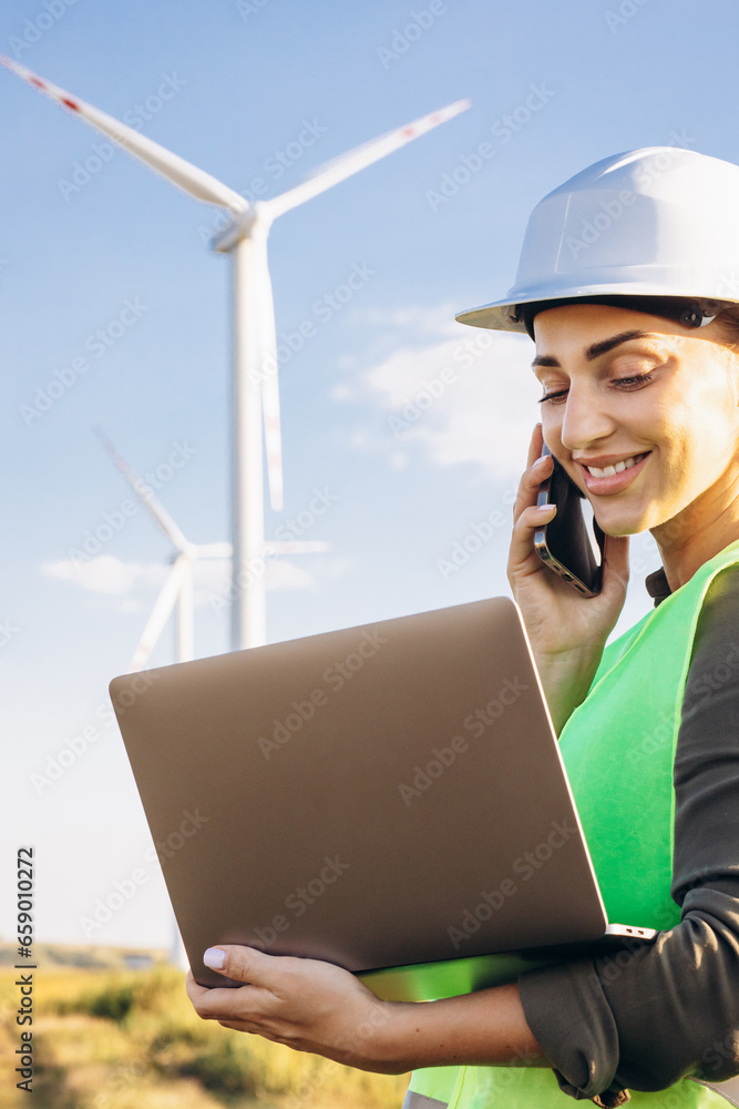 Portrait of woman talking on the phone by the windmill tribunes Portrait of woman talking on the phone by the windmill tribunes
