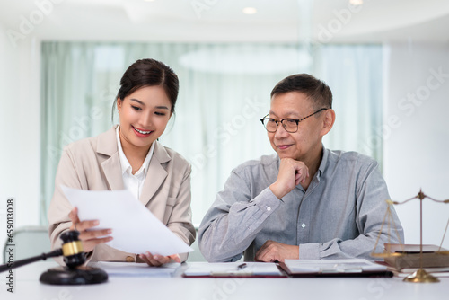 Wallpaper Mural Female lawyer discussing and explaining term of contract with legal agreement to senior businessman Torontodigital.ca