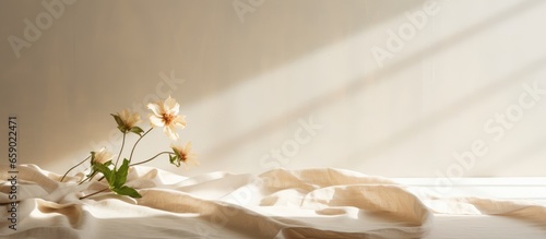 Neutral beige linen texture pleated tablecloth with floral shadows and copy space