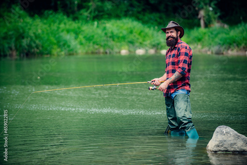 Fototapeta Naklejka Na Ścianę i Meble -  Fisherman caught a fish. Man fishing on river.