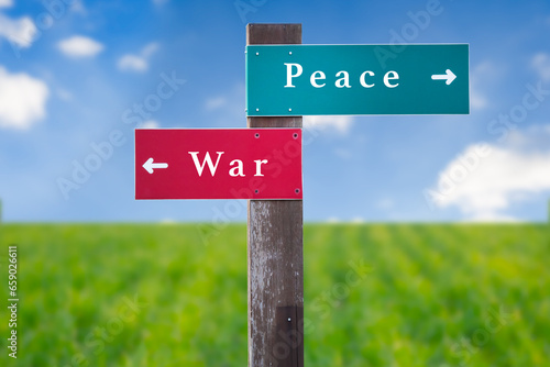 Street Sign the Direction Way to Peace versus War. © Oleksandr