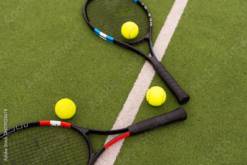 Tennis racket and tennis ball on court. © Angelov